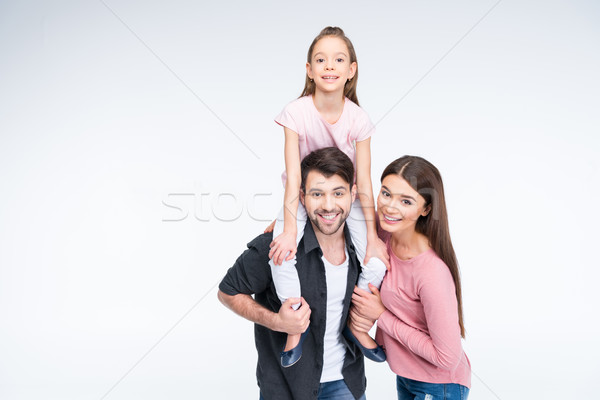 Happy young family with one child having fun together and smiling Stock photo © LightFieldStudios