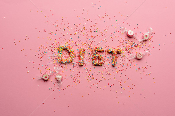 Close-up view of word diet made from sweets isolated on pink, healthy living concept  Stock photo © LightFieldStudios