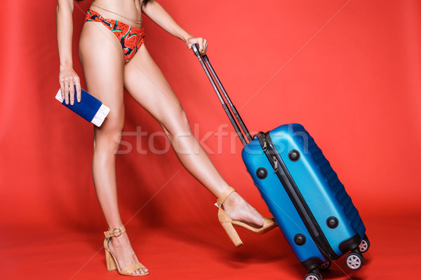 woman in swimsuit walking with suitcase Stock photo © LightFieldStudios