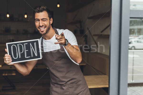 waiter holding chalkboard with open word Stock photo © LightFieldStudios