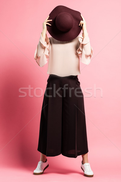 Woman covering face with hat Stock photo © LightFieldStudios