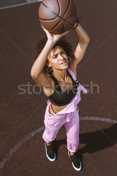 african-american woman throwing basketball Stock photo © LightFieldStudios