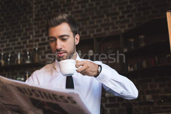 Stock photo: businessman drinking coffee and reading newspaper