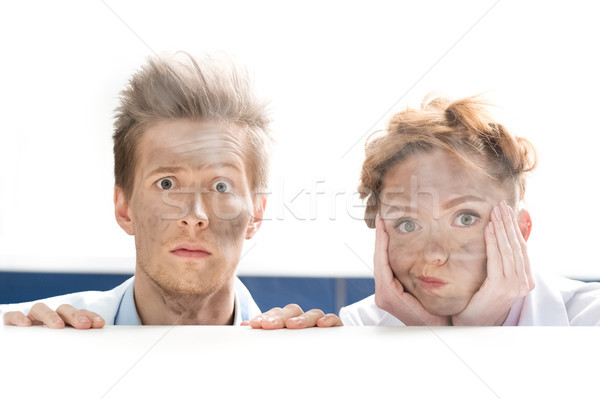 portrait of scientists looking out behind table after experiment on white Stock photo © LightFieldStudios