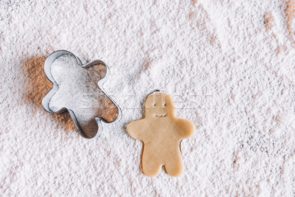 'Close-up view of uncooked gingerbread man and cookie cutter on flour Stock photo © LightFieldStudios
