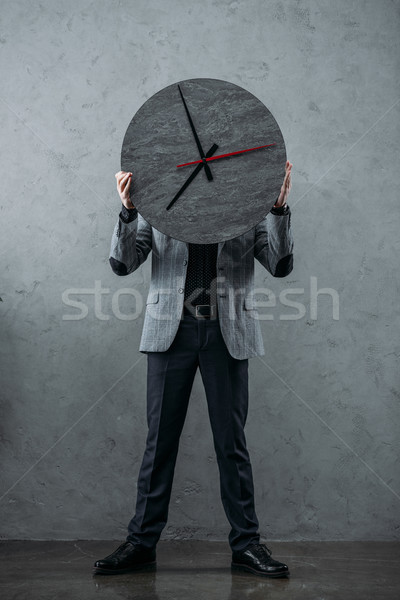 businessman holding clock Stock photo © LightFieldStudios