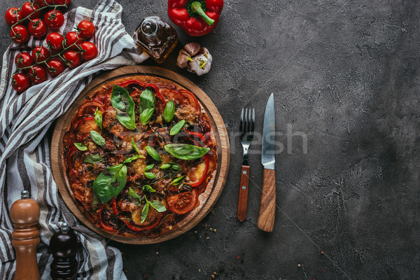 top view of delicious pizza with fork and knife on concrete table Stock photo © LightFieldStudios