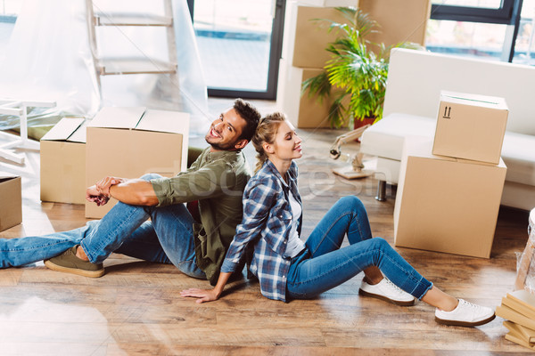 couple with cardboard boxes in new house Stock photo © LightFieldStudios