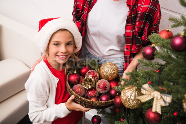 Stock photo: mother and daughter decorating christmas tree
