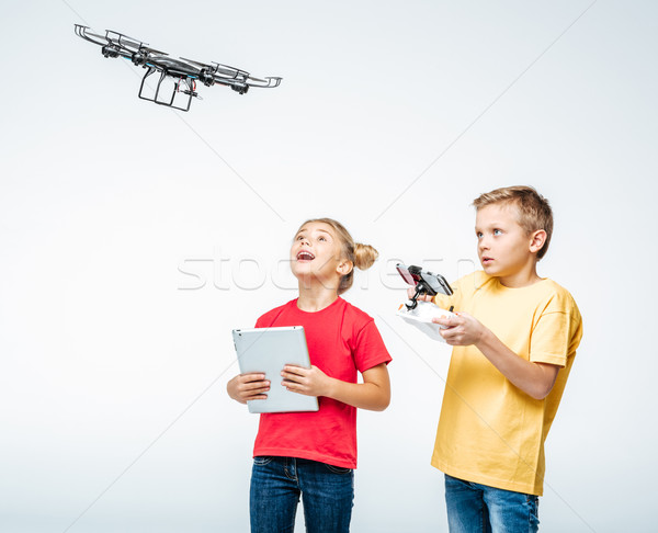Kids using digital tablet and hexacopter drone Stock photo © LightFieldStudios
