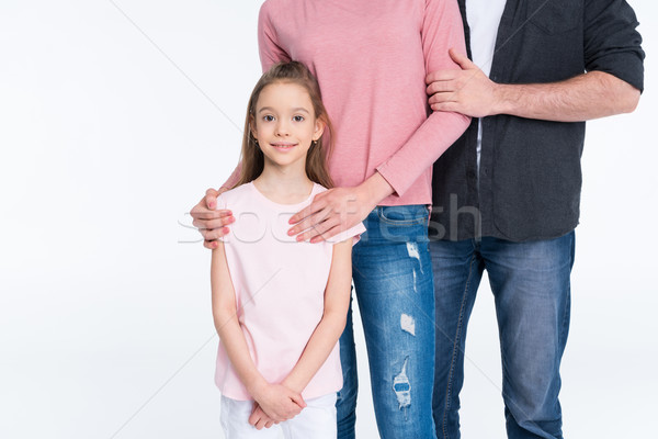 Cropped shot of young family with one child standing together on white Stock photo © LightFieldStudios