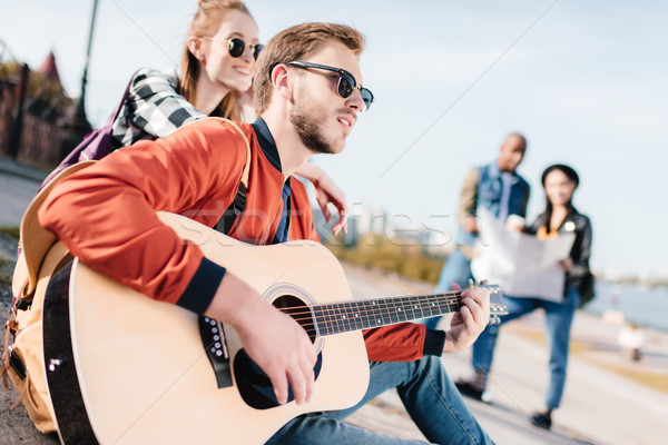 Człowiek gry gitara selektywne focus młody człowiek przyjaciela Zdjęcia stock © LightFieldStudios
