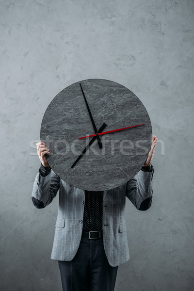businessman holding clock Stock photo © LightFieldStudios