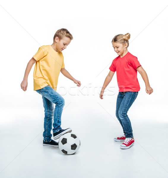 siblings playing with soccer ball Stock photo © LightFieldStudios