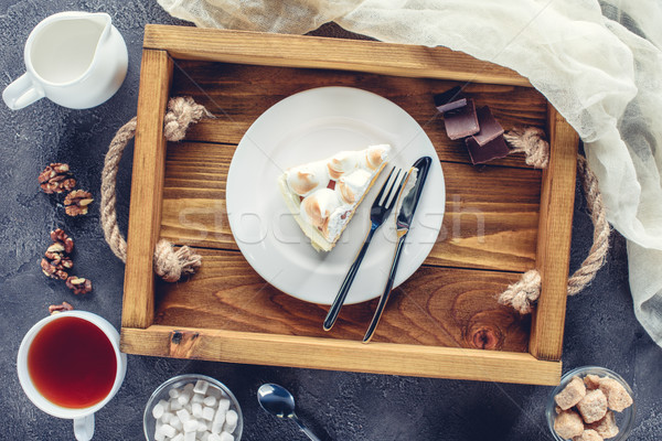top view of delicious piece of cake with meringue on plate on wooden tray Stock photo © LightFieldStudios