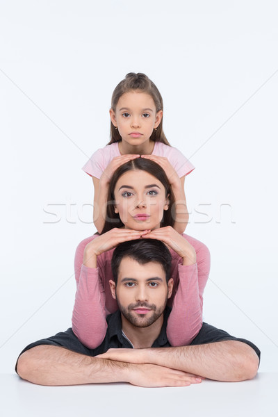 Pensive young family with one child looking at camera on white  Stock photo © LightFieldStudios