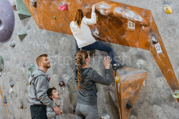 Little girl climbing wall with grips Stock photo © LightFieldStudios