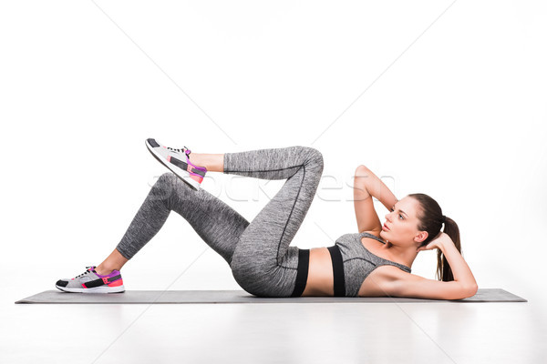 Stock photo: sportswoman exercising on yoga mat