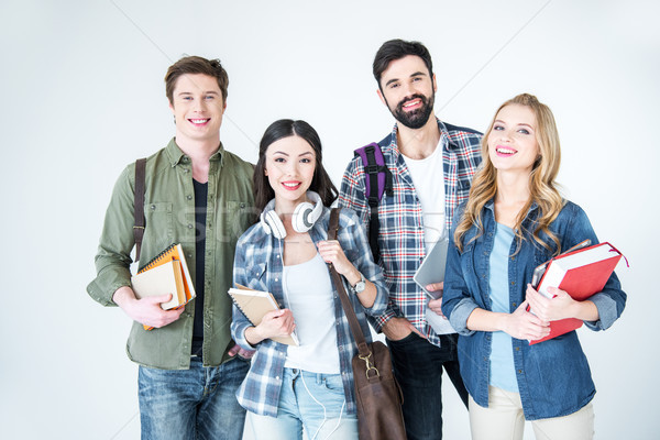 Vier jungen Studenten Kleidung halten Stock foto © LightFieldStudios