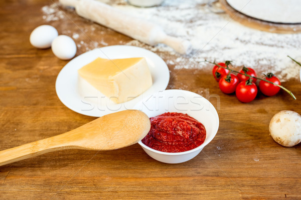 different pizza ingredients, tomato paste and cheese on wooden tabletop Stock photo © LightFieldStudios