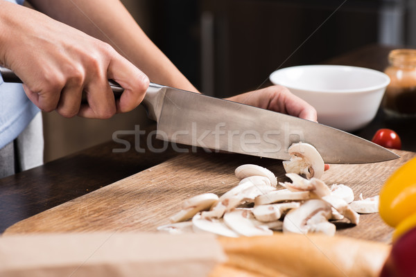 woman cutting mushrooms Stock photo © LightFieldStudios