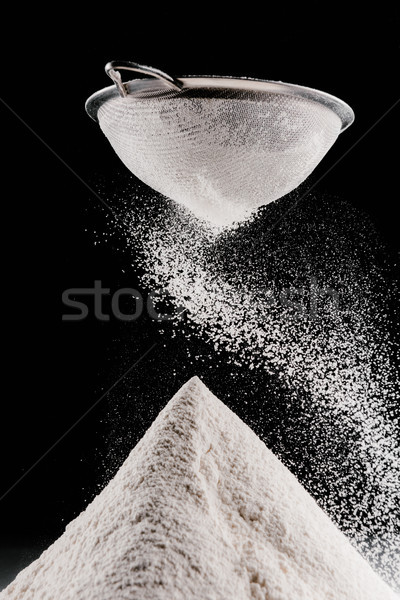 Stock photo: flour falling from sieve on pile isolated on black