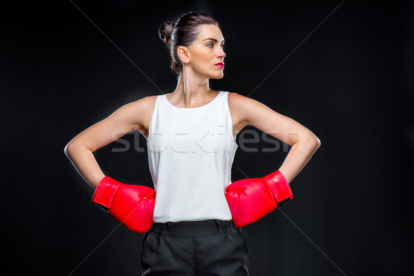 Businesswoman in boxing gloves Stock photo © LightFieldStudios