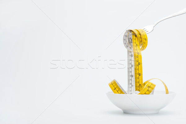 measuring tape on fork isolated on white, healthy living concept Stock photo © LightFieldStudios
