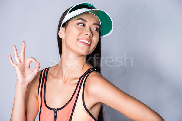 woman in visor showing ok sign Stock photo © LightFieldStudios