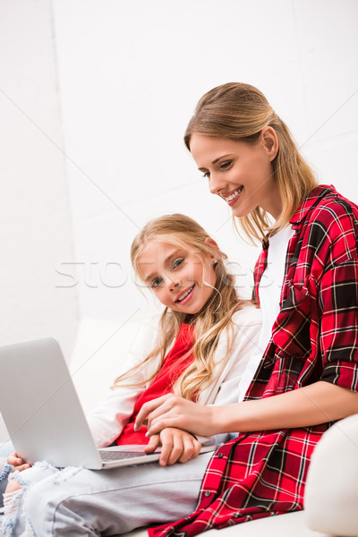 mother and daughter using laptop Stock photo © LightFieldStudios