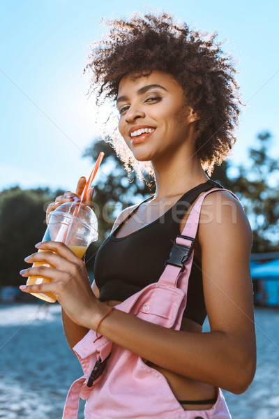 african-american woman drinking juice Stock photo © LightFieldStudios