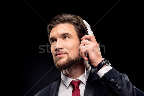 Bonito empresário fones de ouvido retrato branco sorridente Foto stock © LightFieldStudios