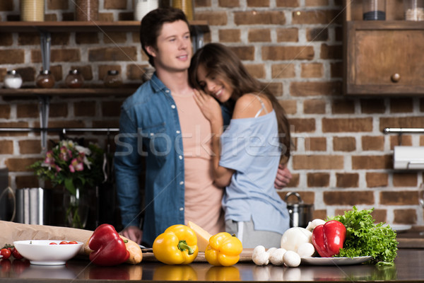 couple hugging in kitchen Stock photo © LightFieldStudios