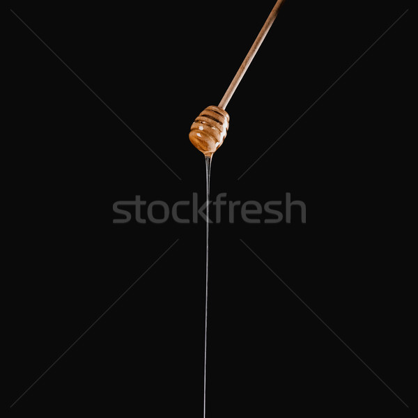 Apetisant miere lipi izolat negru fundal Imagine de stoc © LightFieldStudios