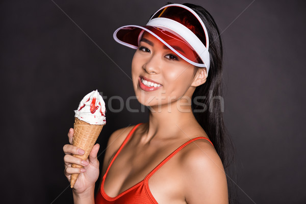 woman in swimsuit and visor holding ice-cream Stock photo © LightFieldStudios