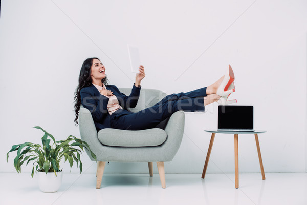 laughing businesswoman using tablet Stock photo © LightFieldStudios