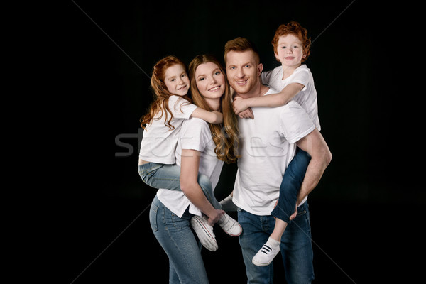 Stock photo: portrait of happy family in white t-shirts isolated on black