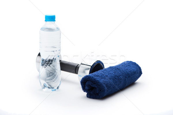 metallic dumbbell, towel and bottle with water isolated on white. equipment sport and healthy living Stock photo © LightFieldStudios