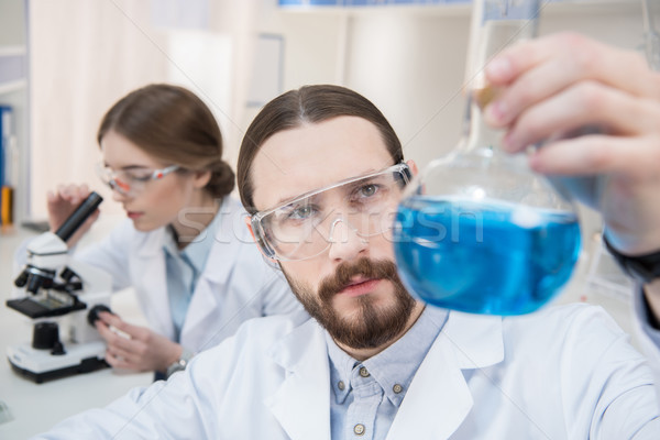 Scientist holding chemical reagent Stock photo © LightFieldStudios