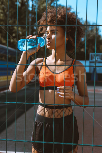 fit african-american woman drinking water Stock photo © LightFieldStudios