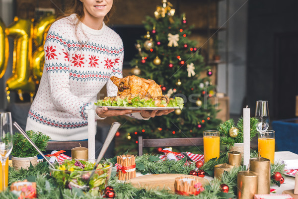woman serving christmas table with chicken Stock photo © LightFieldStudios