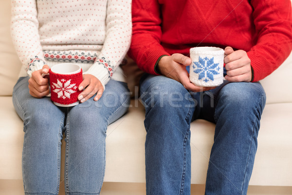 couple with cups at christmastime Stock photo © LightFieldStudios