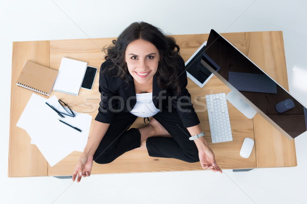 pregnant businesswoman on table in lotus pose Stock photo © LightFieldStudios