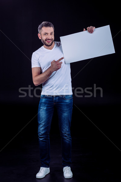 Smiling man holding blank card Stock photo © LightFieldStudios
