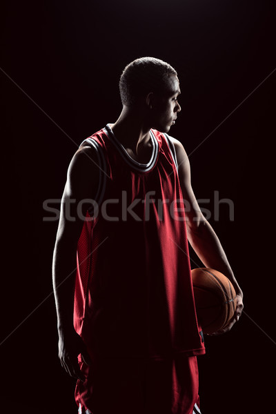 African american basketball player posing with ball on black  Stock photo © LightFieldStudios