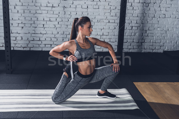 woman stretching on mat Stock photo © LightFieldStudios