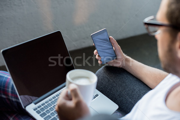 Man with laptop and smartphone Stock photo © LightFieldStudios