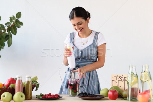 young woman making detox drink Stock photo © LightFieldStudios