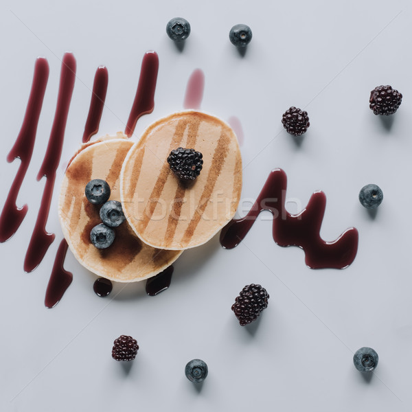 top view of sweet gourmet pancakes with fresh berries and jam on grey Stock photo © LightFieldStudios