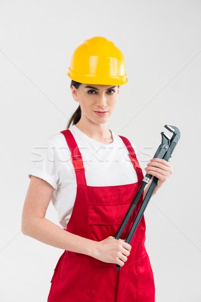 Female builder holding wrench Stock photo © LightFieldStudios